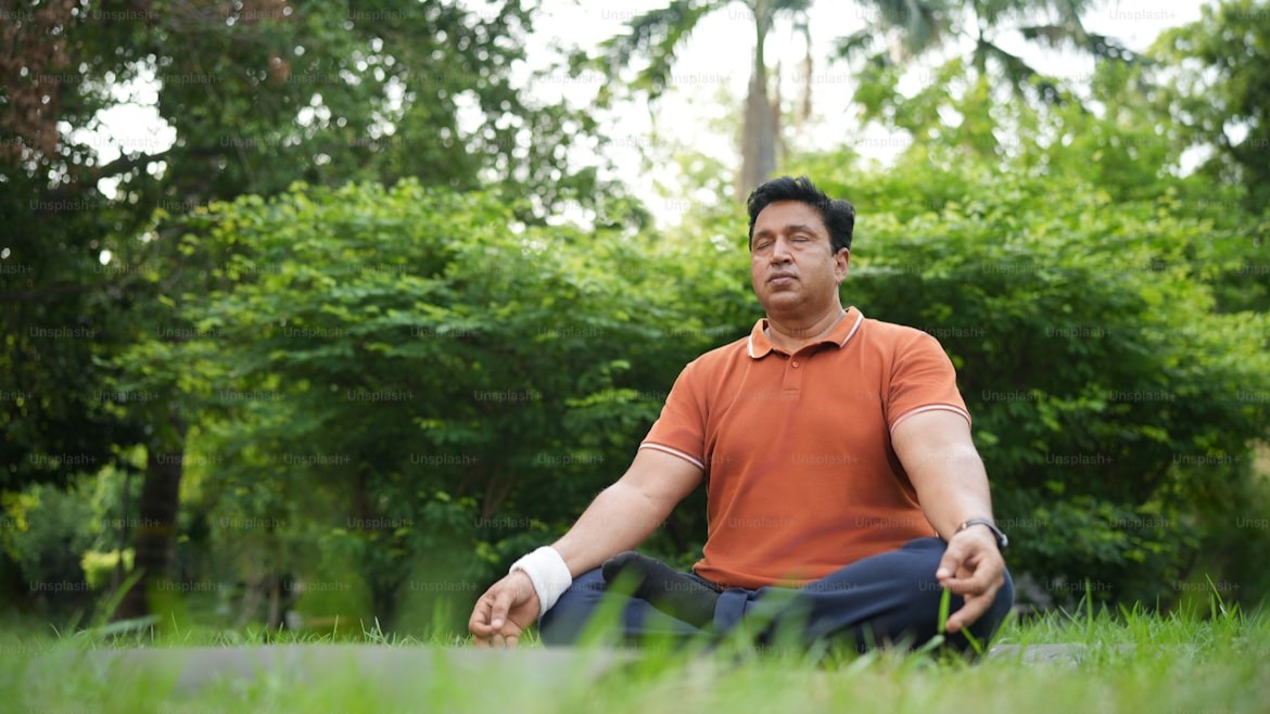 Person meditating in a serene green park, symbolizing mental health benefits from nature
